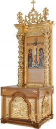 The kiot for the altar is rectangular, wooden, with a door and gilded elements - фото